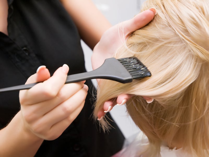 Hairstylist Dyeing a Client's Hair